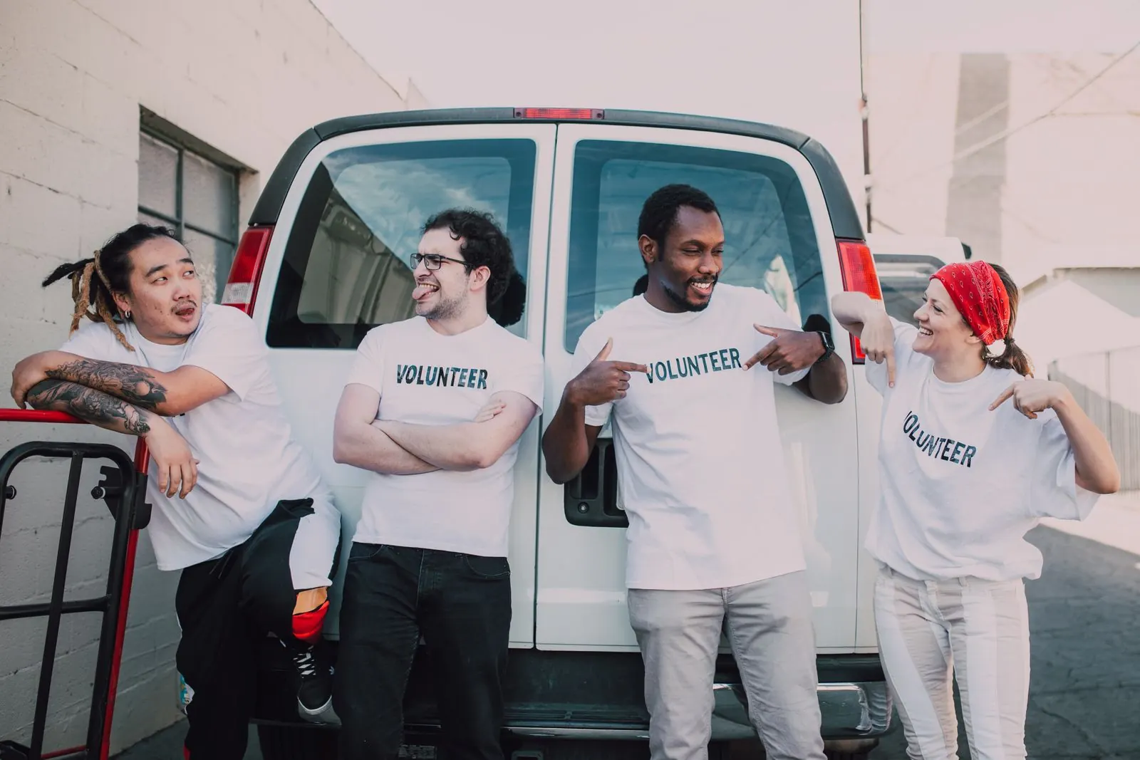 Campaign volunteers in matching T-shirts standing together beside a van